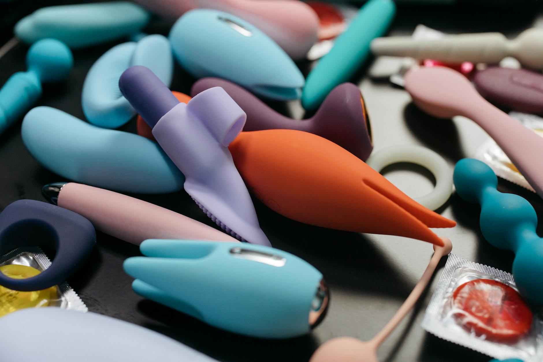 An array of vibrant adult toys including vibrators displayed in close-up, showcasing modern designs for pleasure.