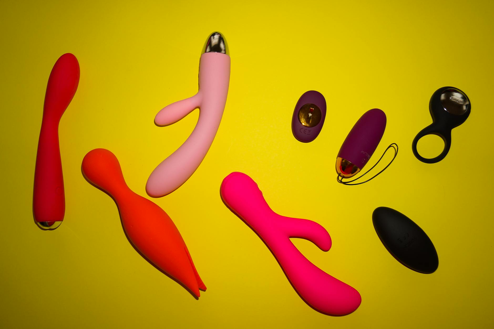 A blue silicone sex toy held in hand against a solid purple background, symbolizing self-love and reconnection